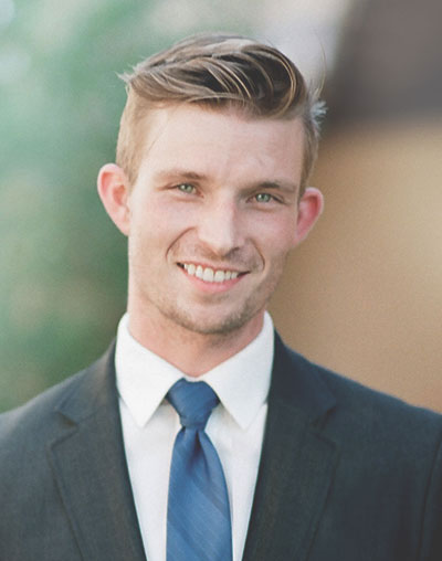 white guy smiling in suit